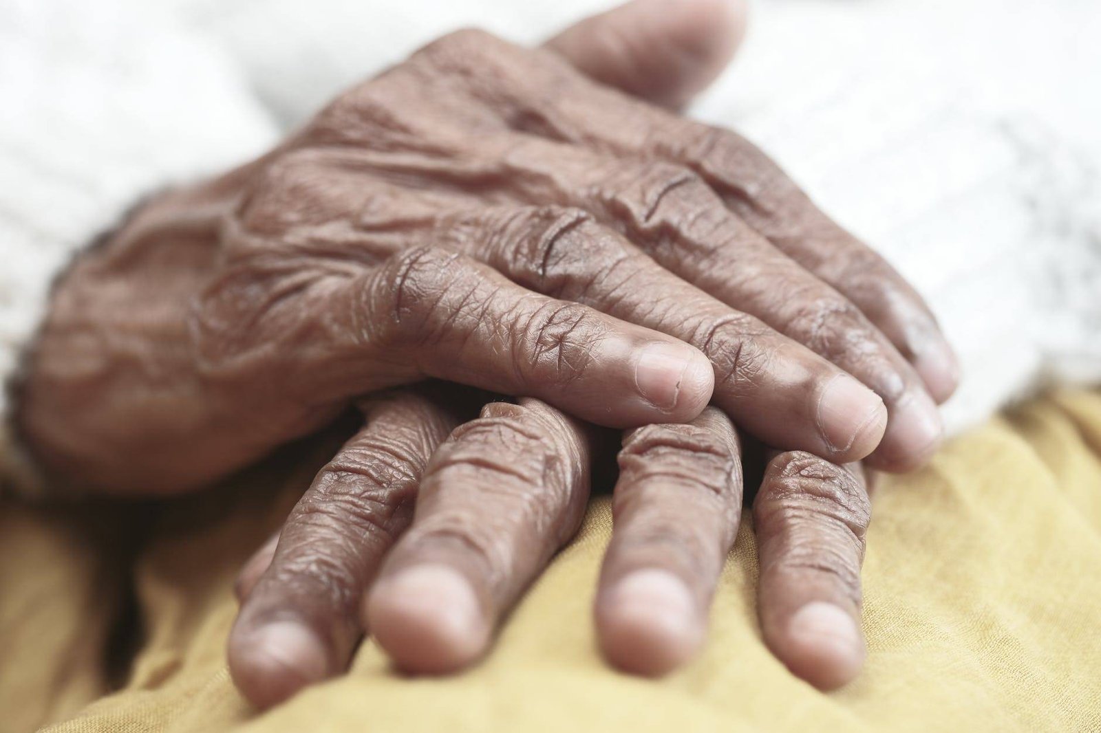 persons hand on white textile