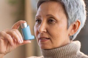 eldery female about to use her asthma inhaler