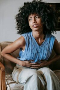 woman in discomfort suffering with crohn's disease